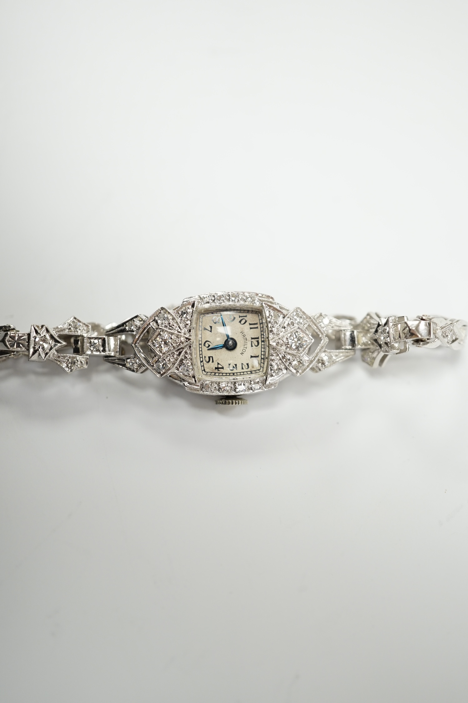 A lady's white metal (stamped irid and platinum) and diamond cluster set manual wind Hamilton cocktail watch, approx. 15cm, gross weight 24.6 grams.